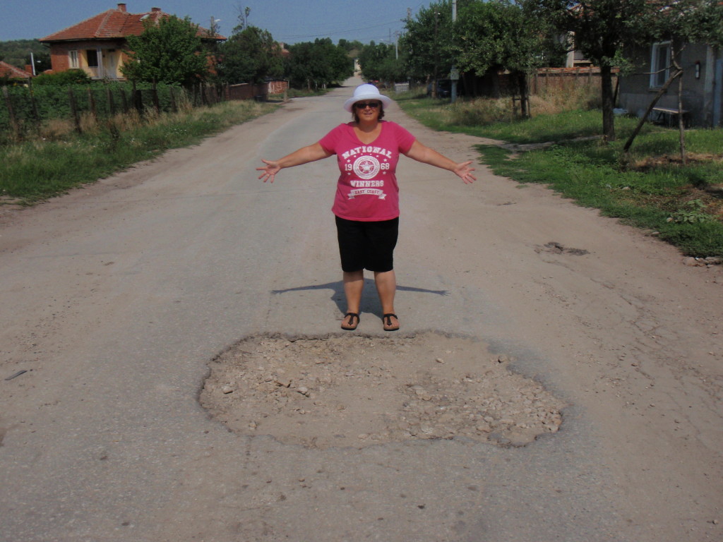 The road outside the campsite , one of the potholes.
